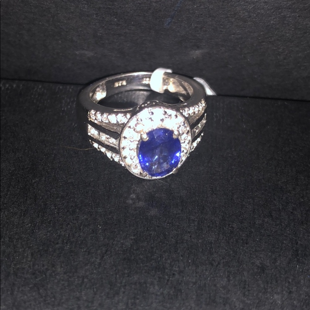 Beautiful Iolite center Stone sourronded by Zicon